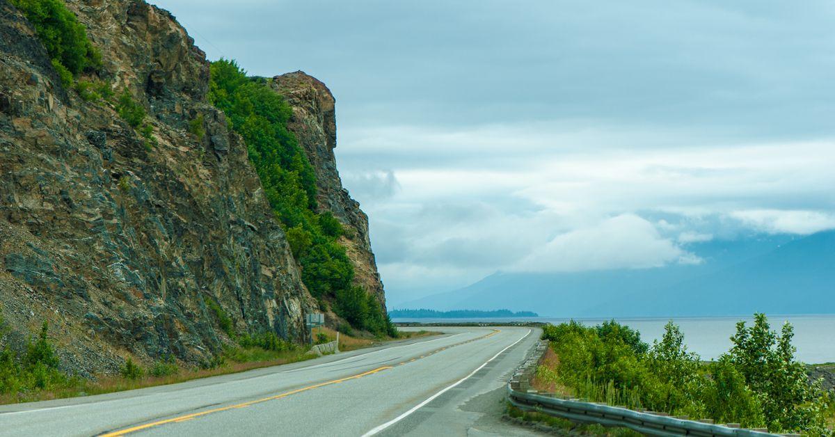 Coastal highway winding along a cliffside with ocean views
